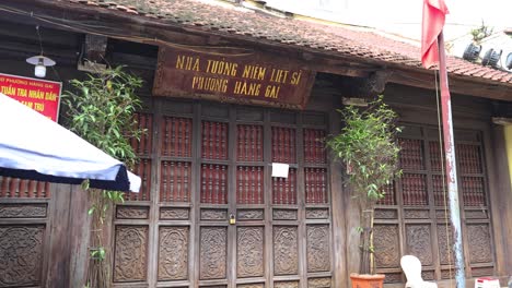 flags waving on a traditional wooden building