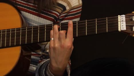 chica de cerca practicando guitarra en la cama