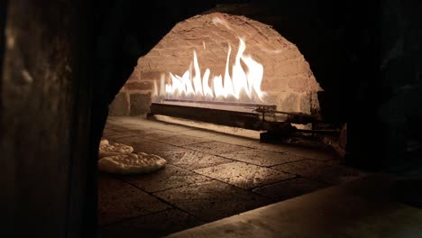 bread inside the oven,removing bread from brick oven,pitta bread,turkish pizza pita inside the oven