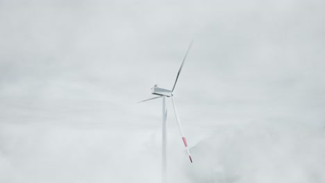 wind turbine in foggy mountain landscape