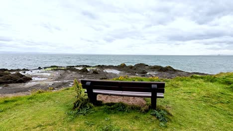 a bench facing the sea in fife, scotland