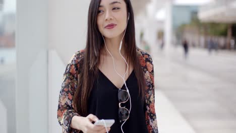 Smiling-young-woman-walking-through-town