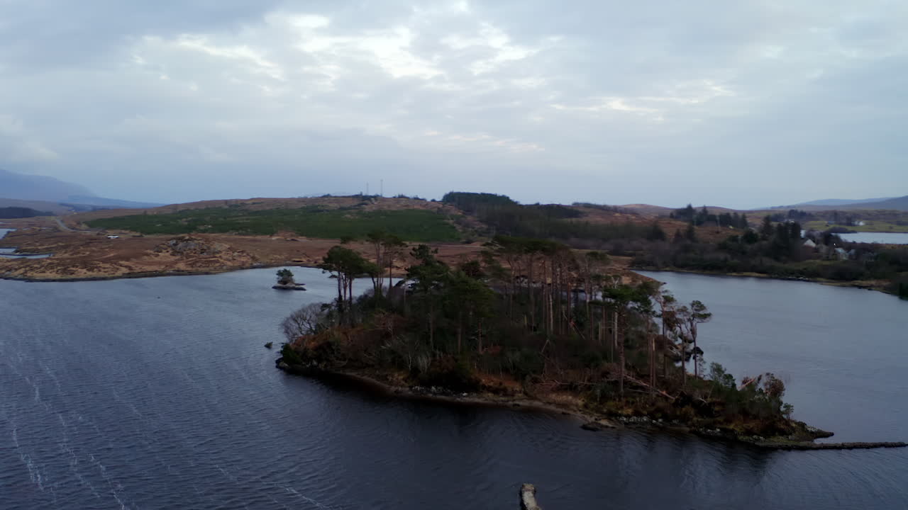 180-degree aerial orbit around Pine Island, unveiling iconic Connemara mountains and breathtaking landscape, Ireland