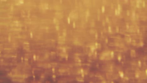 abstract golden particles with blurred defocused bokeh moves chaos, snow flakes