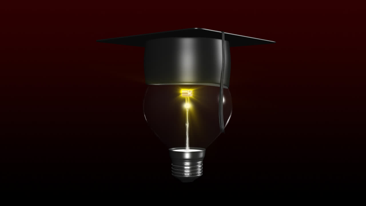Premium stock video - Light bulb with a graduated hat on. concept of ...