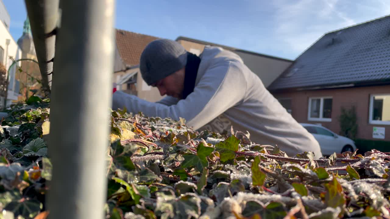 Close up shot of man stretching outdoors after intense run during sunny day in winter