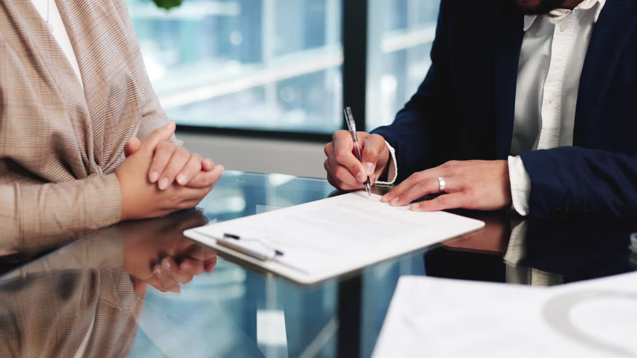 Business Professionals Signing a Contract Document in an Office