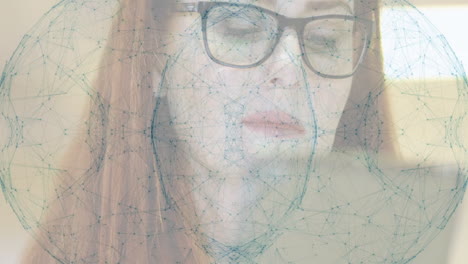 working on laptop, woman with glasses analyzing animation of network connections
