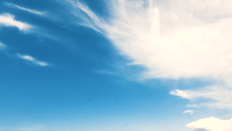 Time-lapse-of-white-clouds-on-a-blue-sky,-the-clouds-move-in-different-directions