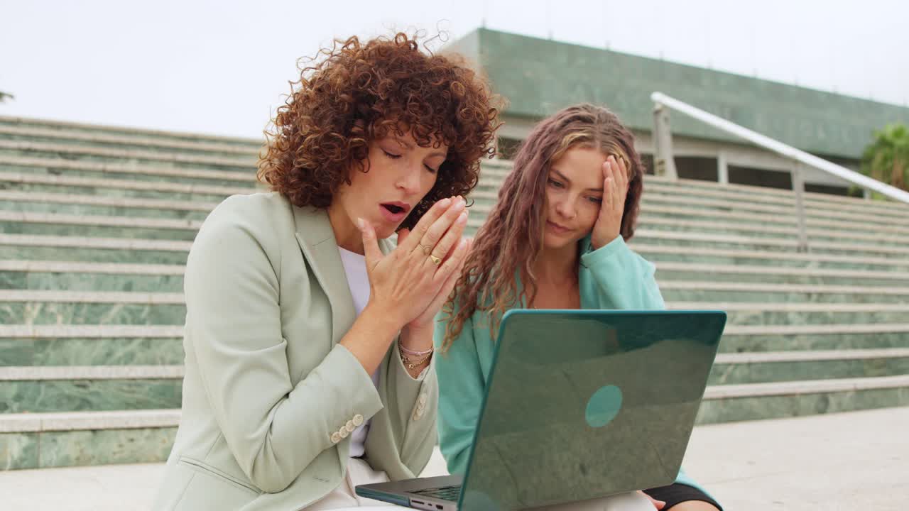 Two Worried Business Women With Laptop