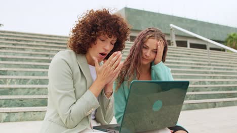 two worried business women with laptop