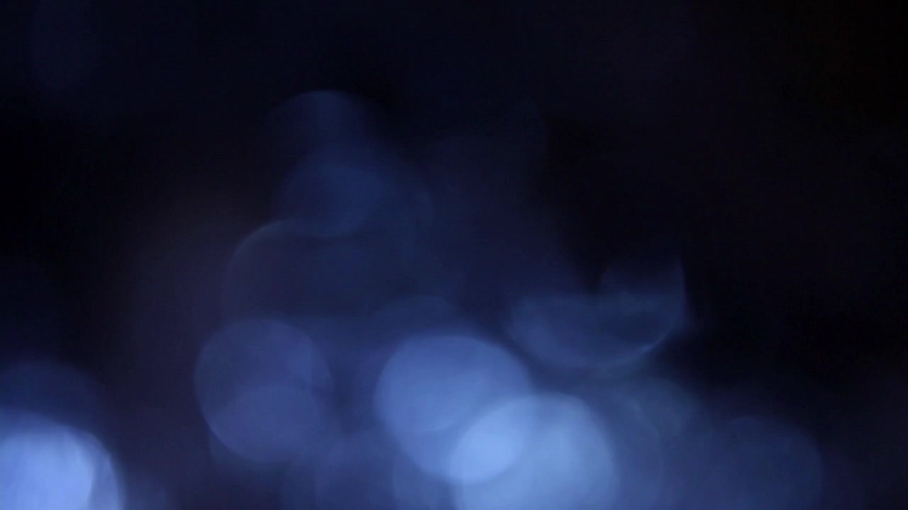 Soft Blue Bokeh Lights Shimmering on Dark Background
