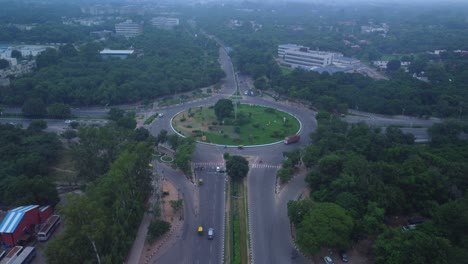 the tribune chowk roundabout surrounded with green trees, tribune newspaper publisher office building in view, chandigarh, drone shot