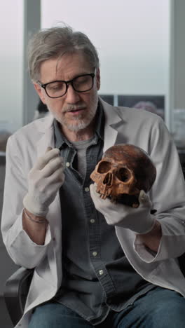 professor examining an ancient skull