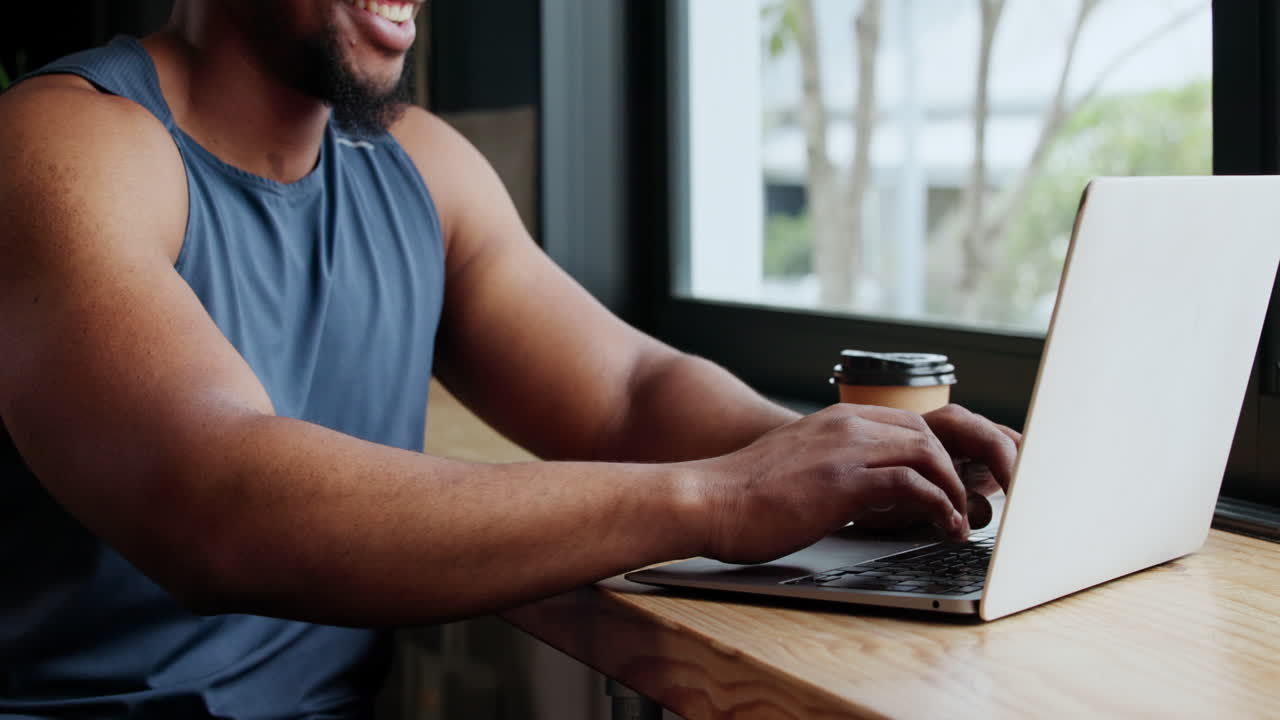 Man working on laptop in a cafe
