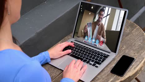 Caucasian-woman-using-laptop-on-video-call-with-male-colleague-working-from-home