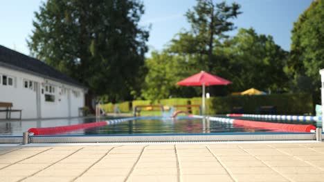 Slow-motion-tracking-shot-of-a-swimmer-swimming-towards-the-camera,-long-shot