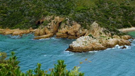 sea caves on rocky coastline at scenic knysna heads, garden route, south africa