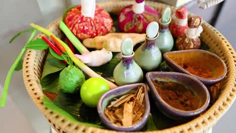 a vibrant display of thai herbal compresses and ingredients, showcasing traditional massage elements in a serene setting