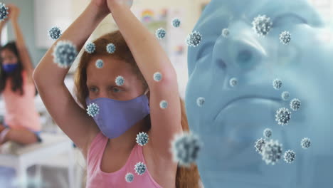 animation of model head with covid 19 cells and schoolgirl in classroom wearing face masks