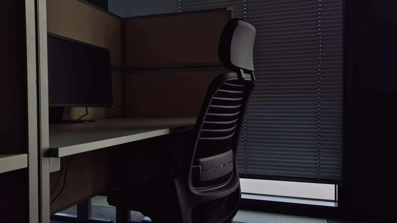 Office cubicle with desk, chair, and computer monitor