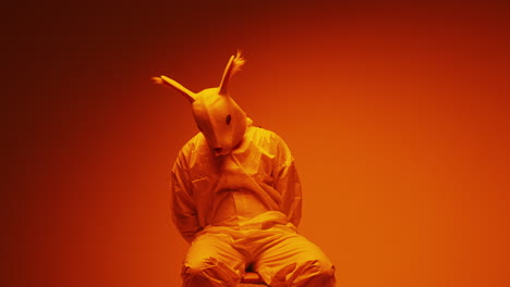 person in bunny mask and hazmat suit