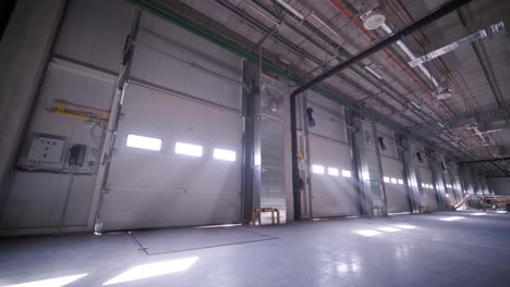 construction process of a big, modern warehouse with multiple garage gates for easy access and transportation of goods.