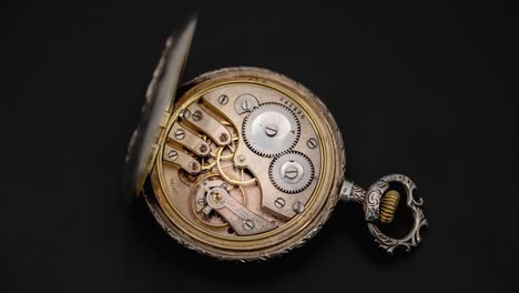 open pocket watch with visible mechanical movement