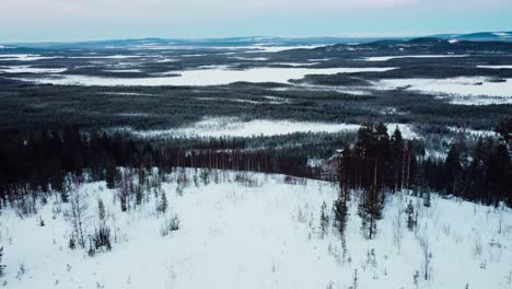 drone shot of a winter landscape in the arctic circle with mountains and a frozen lake