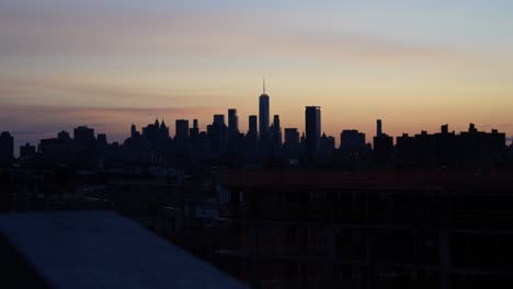 new york city skyline with world trade center viewed from brooklyn office building at beautiful sunset