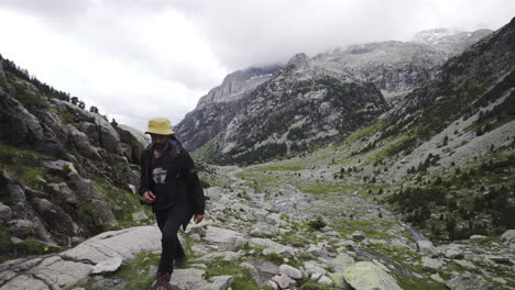 male reaching top of uphill mountains path in aigüestortes national park in the catalan pyrenees spain