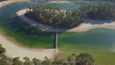 Aerial-drone-view-of-the-small-island-in-the-middle-of-the-lake-in-the-tropical-paradise-looked-in-the-Netherlands,-Europe