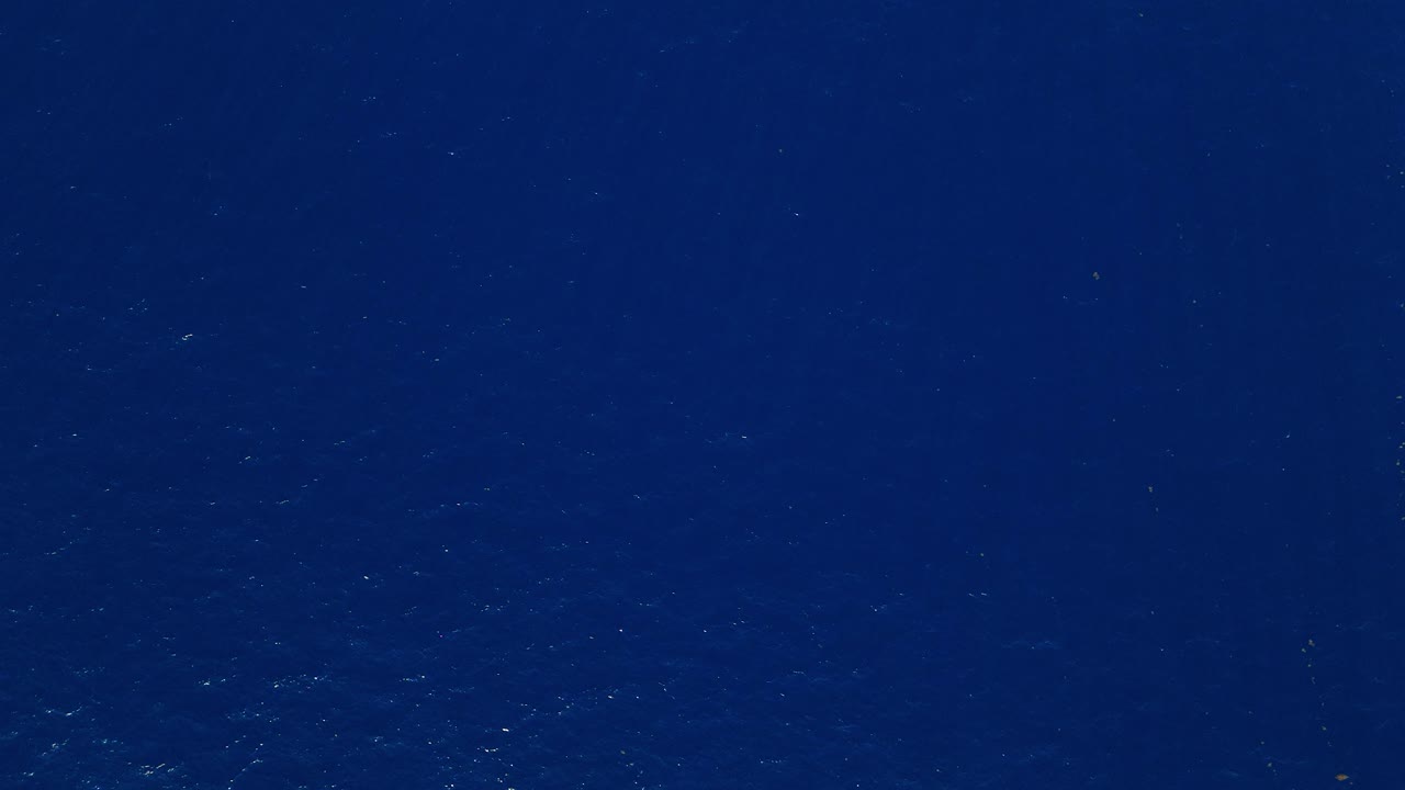 Aerial bird's eye view top down on deep blue ocean creating a soothing and expansive background