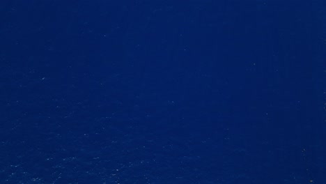aerial bird's eye view top down on deep blue ocean creating a soothing and expansive background