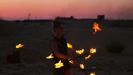 professional dancers women make a fire show and pyrotechnic performance at the festival with burning sparkling torches