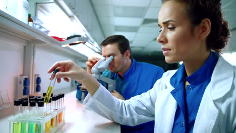 group of doctors working with microscope in medical laboratory