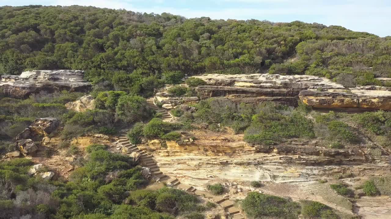 Aerial Flight in Royal Nationalpark - Sydney, Australia Flying toward a set of Stairs made out of Sandstone