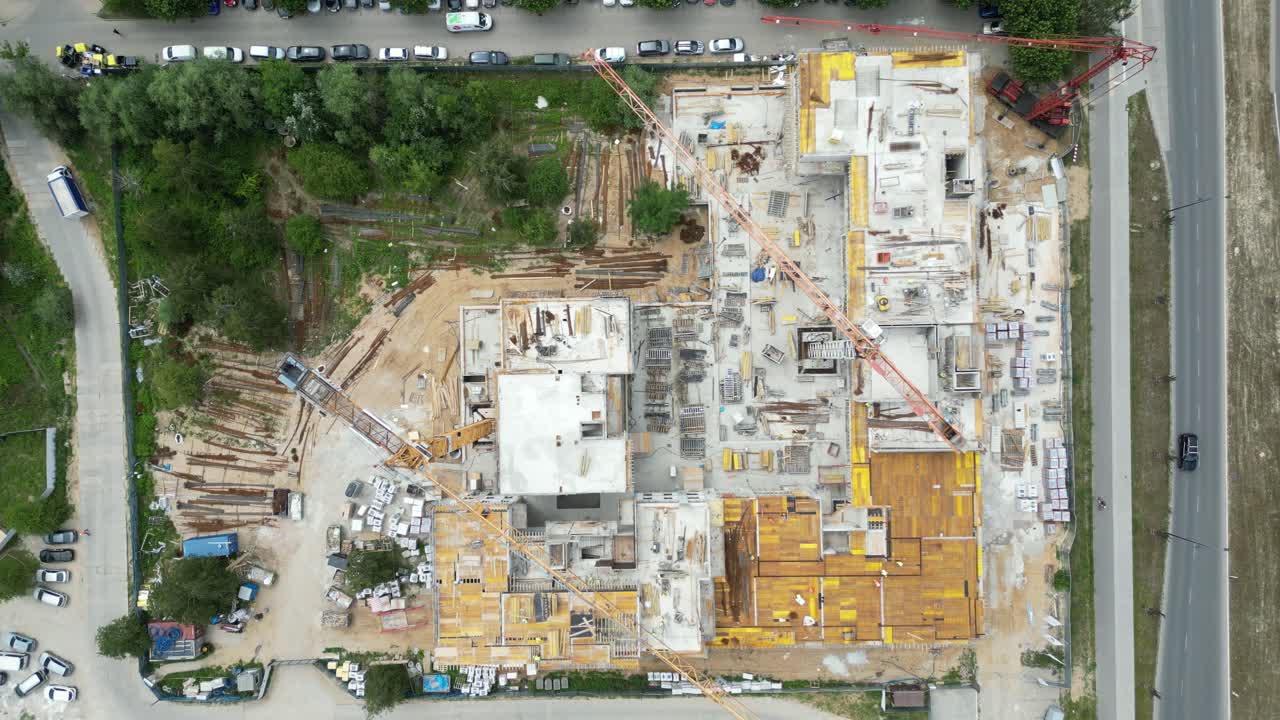 Aerial view of construction site with crane and building. Top view of big development construction and architecture