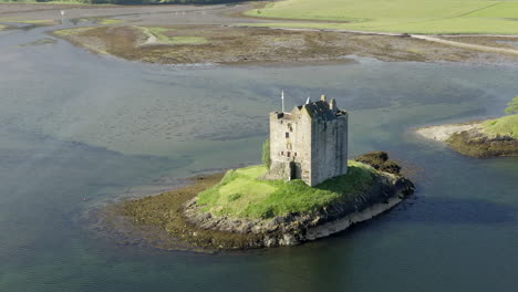 An-aerial,-close-view-of-Castle-Stalker-on-Loch-Laich-on-a-sunny-morning