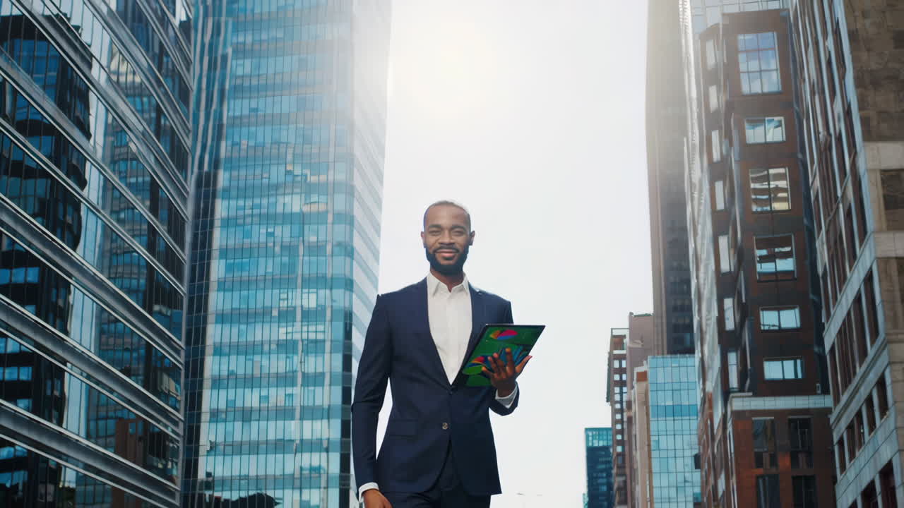 African American businessman using tablet in city financial district