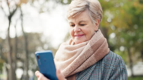 senior woman using smartphone outdoors