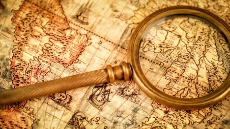 Vintage-magnifying-glass-lies-on-an-ancient-world-map