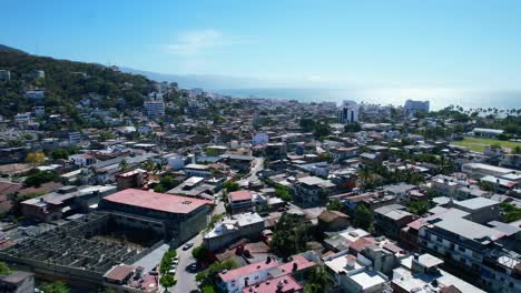 Mexican-beach-town-of-Puerto-Vallarta-skyline-on-sunny-summer-day,-aerial