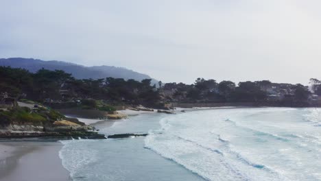 Aerial-Southbound-Flyover-of-Carmel-by-the-Sea-Beach-with-Carmel-Cypress,-Homes,-Santa-Lucia-Range-and-Pt