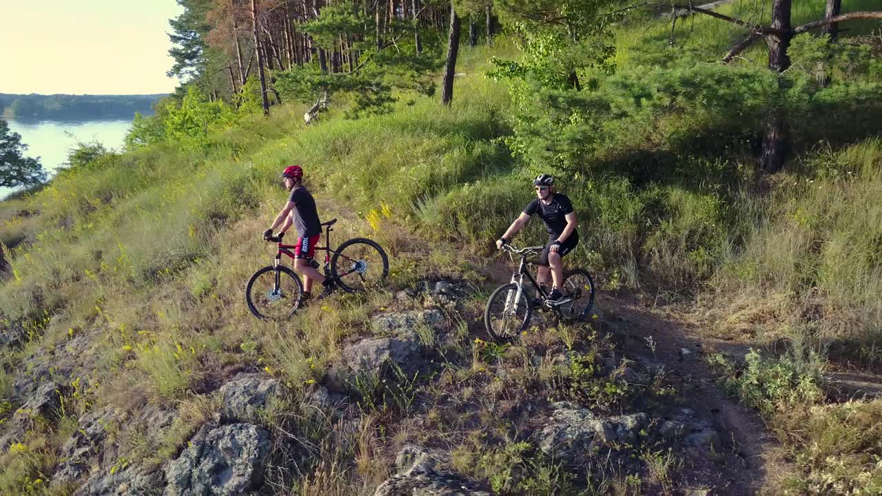 Men Running On A Mountain Bike. Professional cyclist riding the bike on the mountain rocky trail