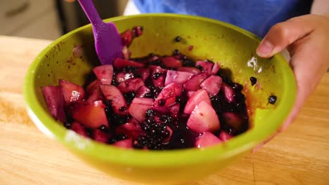 close up mixing fruit for pie filling