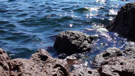 waves crashing against rocks at the shore