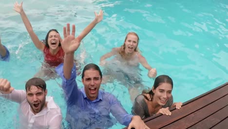 happy friends with clothes in the pool