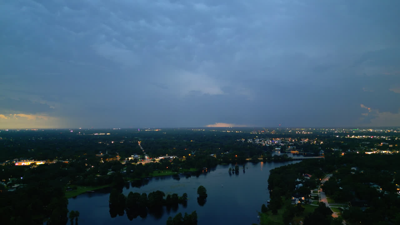 Lightning storm above Tampa at golden hour with yellow-orange flashes in glowing clouds