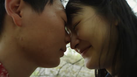 romantic asian girlfriends touching foreheads